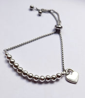 Adjustable heart charm bracelet.